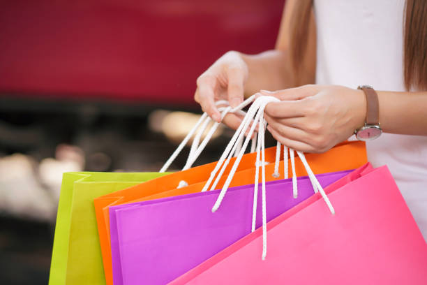 istock hand woman hold shopping bag. 1359116694