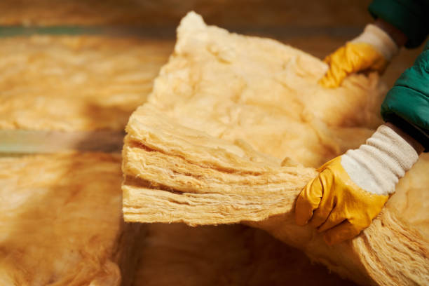 istock Construction worker thermally insulating house attic with glass wool. 1359116846