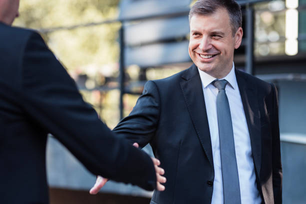 istock Happy Businessman smiling and getting into a handshake with his CEO 1359118933
