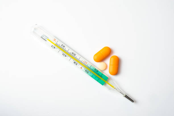 retro thermometer and pills isolated on white background