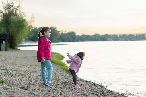 Two girls playing at the beach of Silver lake in Serbia