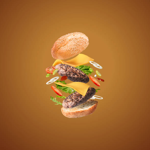 istock tasty cheese burger with flying ingredients on brown background with copyspace 1359127452