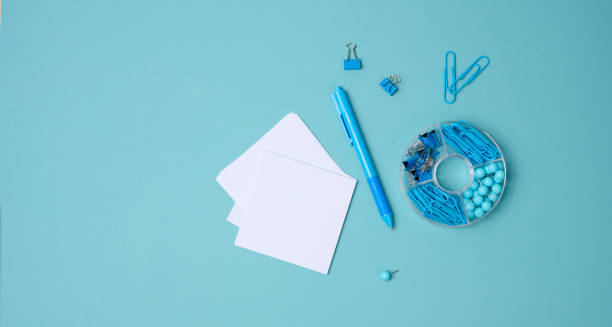 istock stack of white square sheets of paper for notes, stationery on blue background, top view 1359128526
