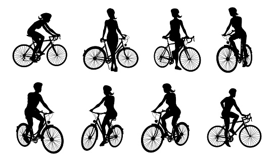 A set of bicyclists riding bikes and wearing a safety helmet in silhouette