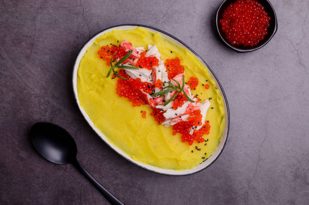 istock Yellow puree with crab meat and red caviar. 1359130811