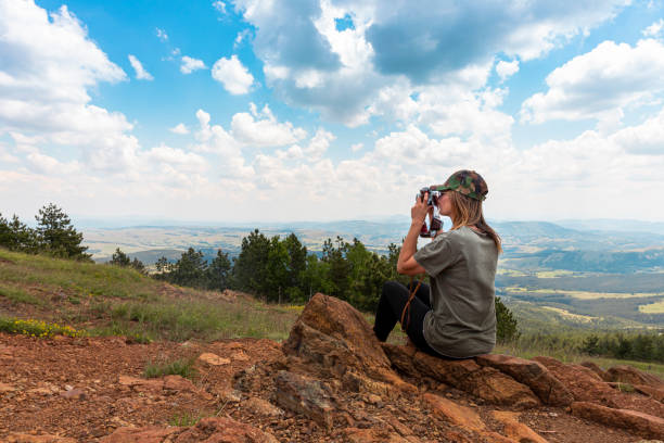 tourist girl photographing with vintage photo camera at the top of the mountain peak - tourist photographing armed forces military imagens e fotografias de stock