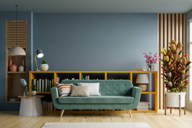 istock Empty living room with green sofa on empty dark blue wall background. 1359131291