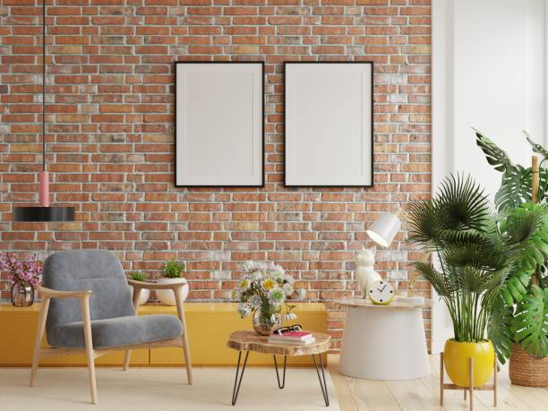 istock Poster mockup with vertical frames on empty brick wall in living room interior with dark velvet armchair. 1359131859