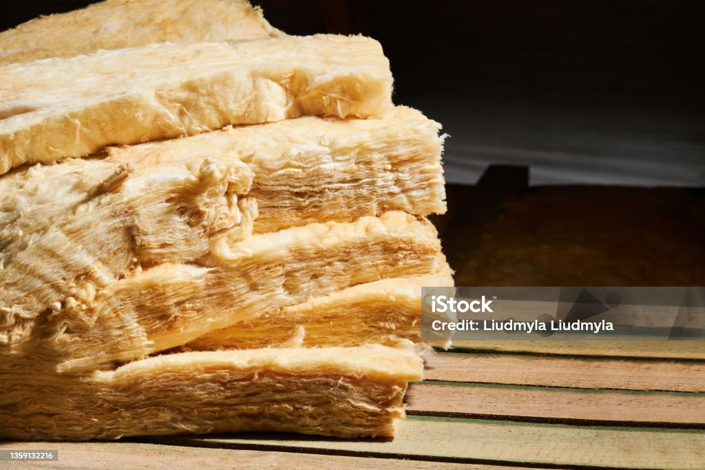 Stack of fiberglass insulation material. Stack of fiberglass insulation material. Mineral wool insulator for heat and cold protection. Insulation Stock Photo