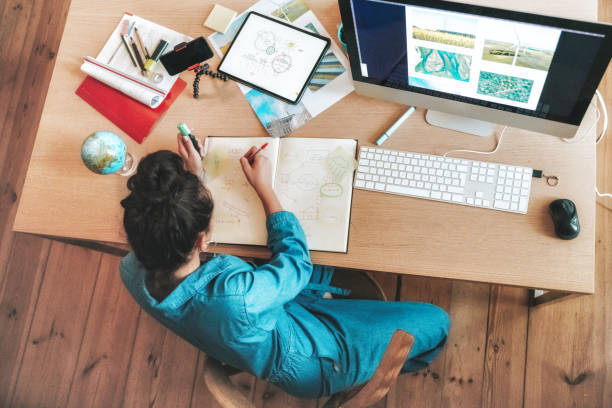 istock overhead view on young woman doing research at desk 1359134212