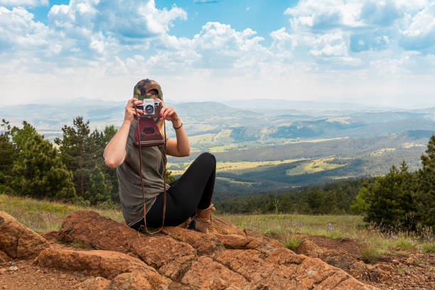 tourist girl photographing with vintage photo camera at the top of the mountain peak - tourist photographing armed forces military imagens e fotografias de stock