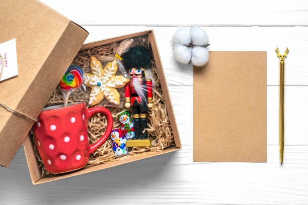 istock Handmade care package, seasonal gift box with candies, cup on white table Personalized eco friendly basket for family, friends, girl for thanksgiving, xmas, Christmas, mothers, fathers day Flat lay 1359136967
