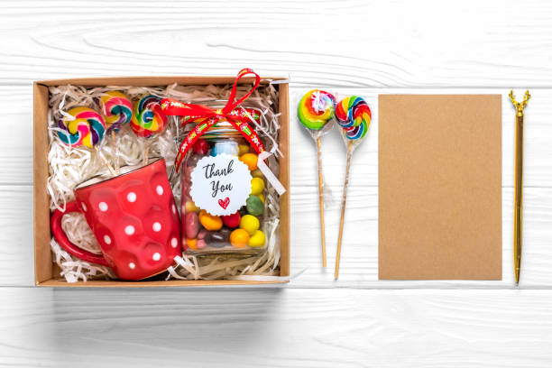 istock Handmade care package, seasonal gift box with candies, cup on white table Personalized eco friendly basket for family, friends, girl for thanksgiving, xmas, Christmas, mothers, fathers day Flat lay 1359137242