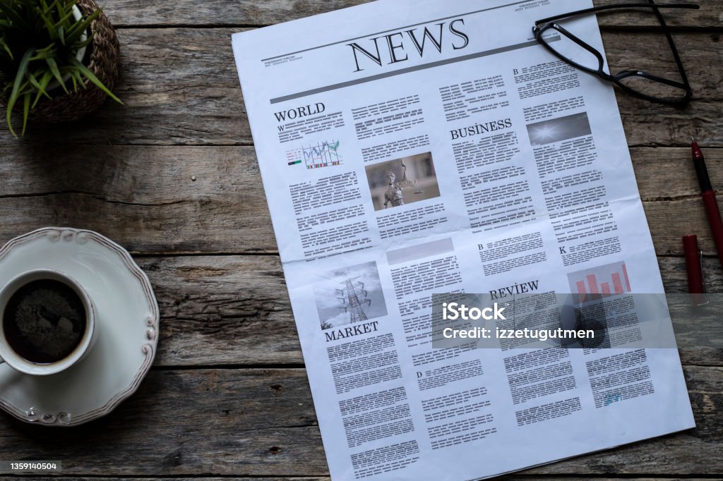 daily newspaper over wooden table Newspaper Stock Photo