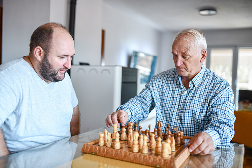 Father Showing Son New Chess Moves