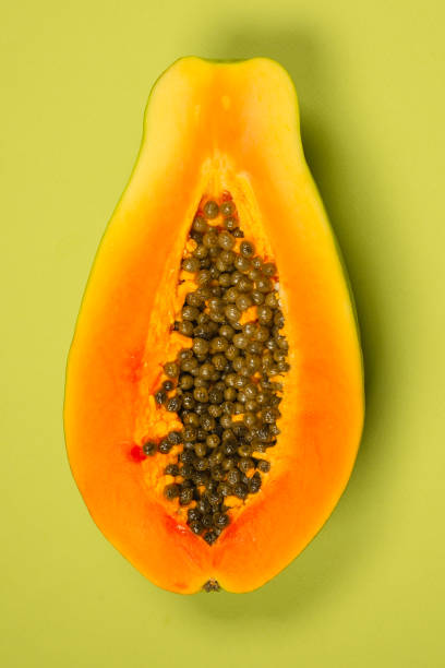istock Papaya fruit on a green background. Half papaya. 1359141418