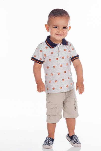 istock Boy looking at the camera in a cute portrait in a studio 1359143457