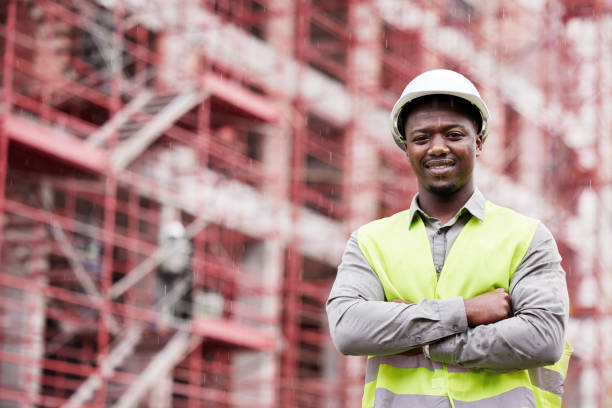 istock Cropped portrait of a handsome young construction worker standing with his arms folded on a building site 1359144113