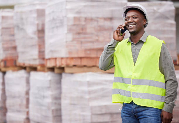 istock Cropped shot of a handsome young construction worker making a phonecall while standing on a building site 1359144119