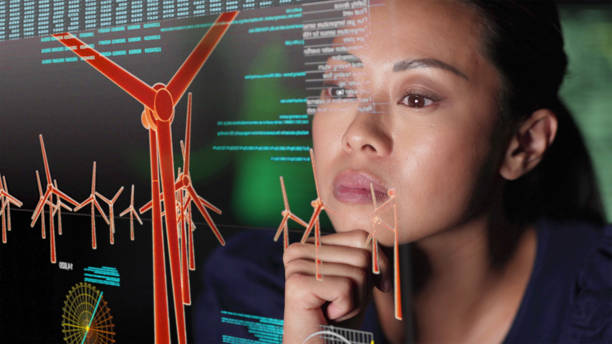 Wind farm design Close up image of a young Asian woman studying wind farm data on a see through (see-thru) computer display in her office. renewable energy photos stock pictures, royalty-free photos & images