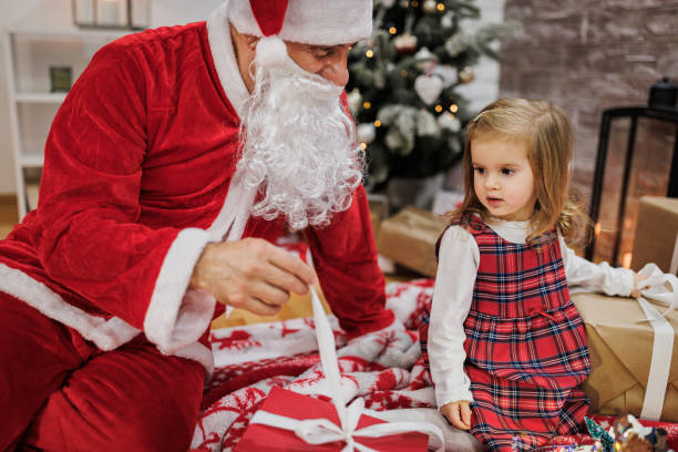 istock Santa is playing with a girl 1359148548