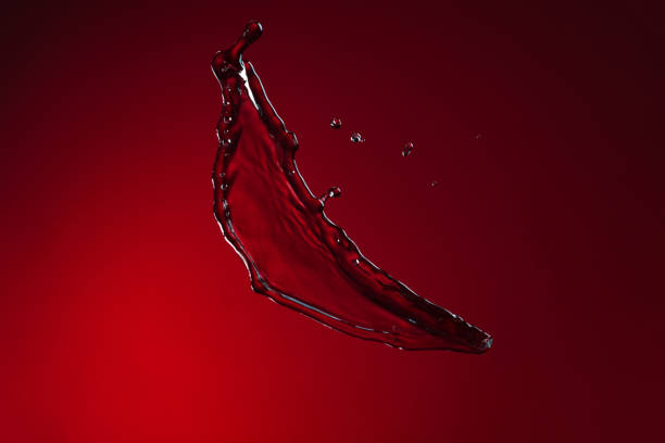 istock Colorful image of wine splash isolated over dark red background 1359148572