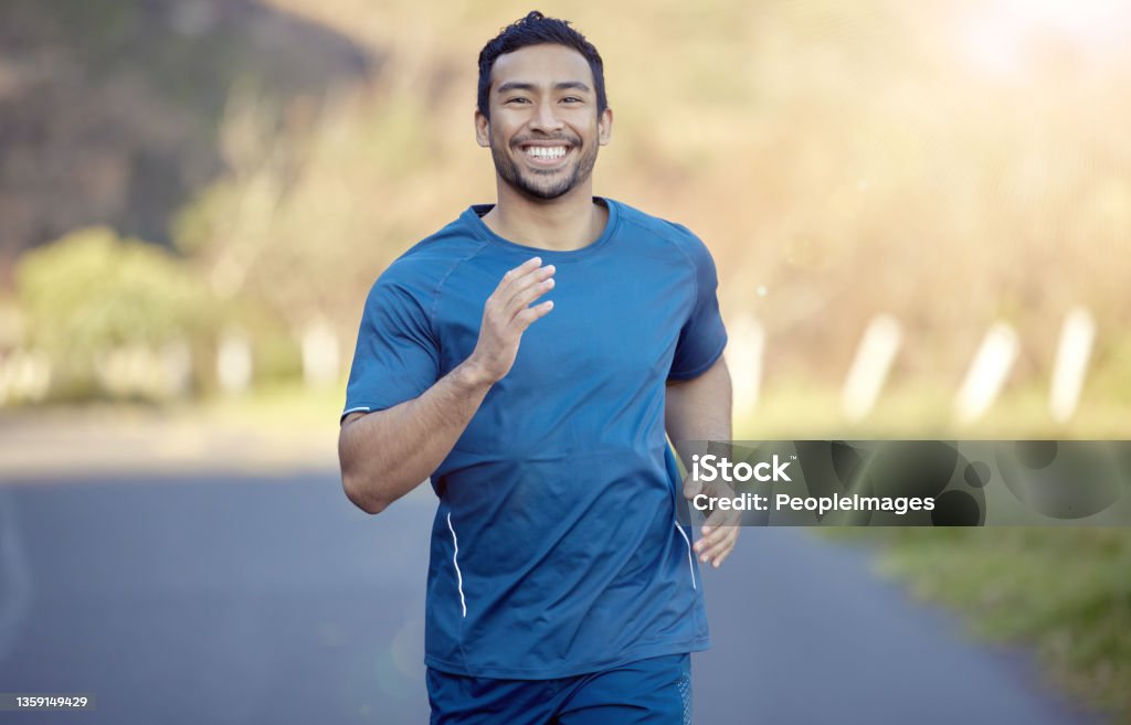Shot of a handsome young man running alone outside during the day I've always been one to chase my dreams 20-29 Years Stock Photo