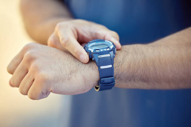 Close up image of men wrist watch laid on a fence in the dark atmosphere