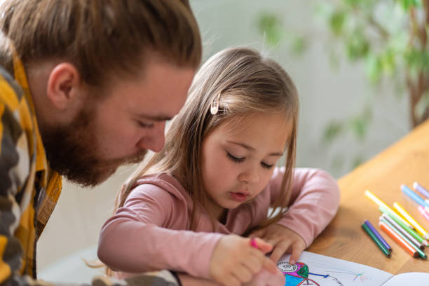 istock Father and daughter drawing together 1359150615