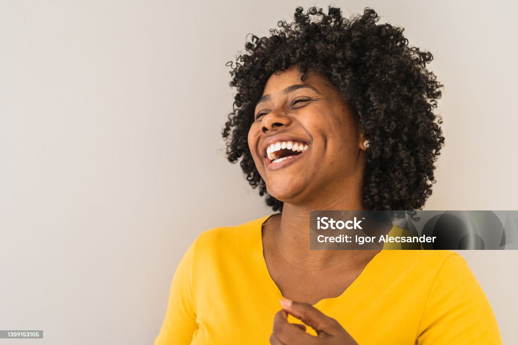 Portrait of a young woman laughing Portrait of a young woman laughing. One Woman Only Stock Photo