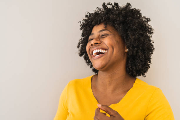 portrait of a young woman laughing - laughing imagens e fotografias de stock