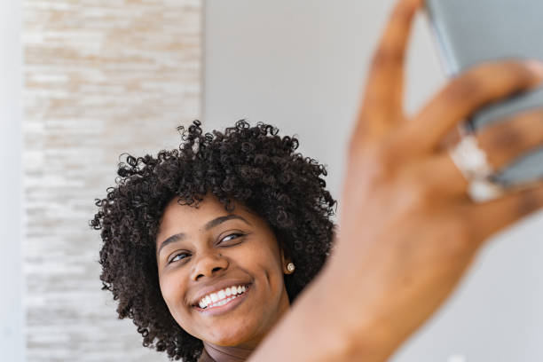istock Smiling black woman taking a selfie 1359153147