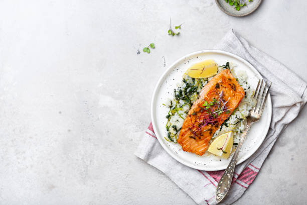 istock salmon steak with lemon rice and spinach 1359153246