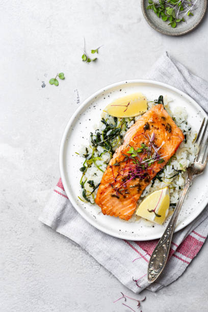 istock salmon steak with lemon rice and spinach 1359153249