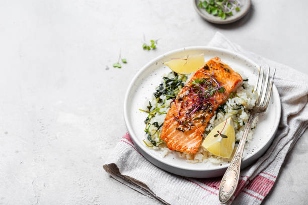 istock salmon steak with lemon rice and spinach 1359153273