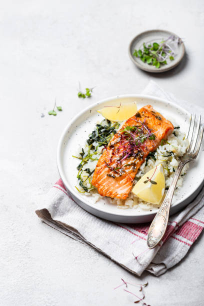 istock salmon steak with lemon rice and spinach 1359153284