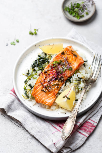 istock salmon steak with lemon rice and spinach 1359153292