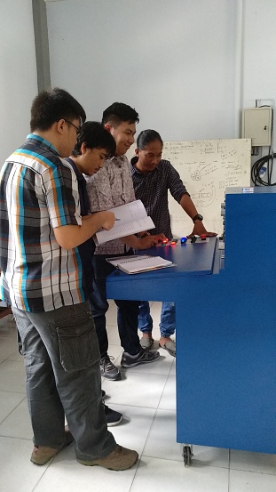 Indonesia, February 2018 - electrical engineering students doing practice in high voltage lab