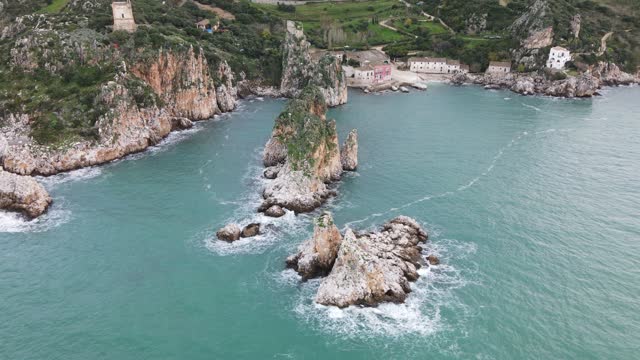 Faraglioni of Scopello in Sicily, Italy. Rocks over the sea, aerial view from drone