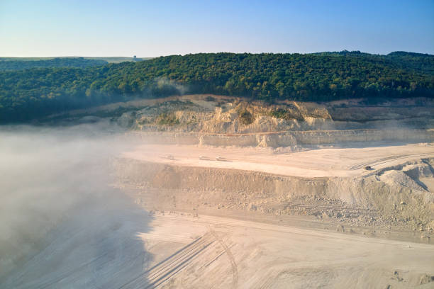 istock Aerial view of open pit mining site of limestone materials extraction for construction industry with excavators and dump trucks. 1359155753