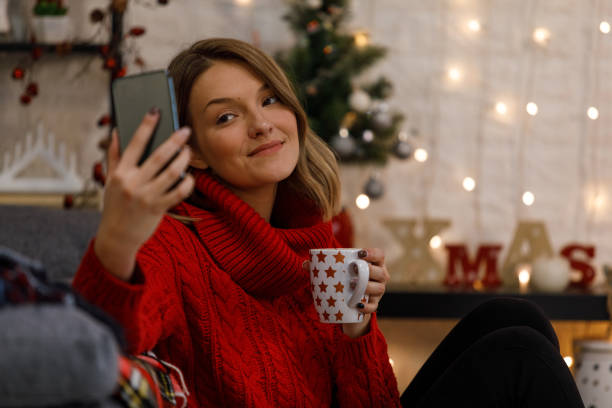 istock Woman taking selfies while enjoying a cup of hot chocolate 1359159337