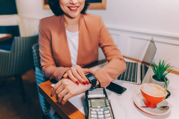 istock Woman paying with smart watch 1359160132