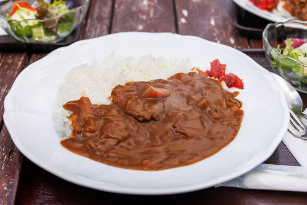 istock Warm and delicious curry rice and fresh salad 1359160142