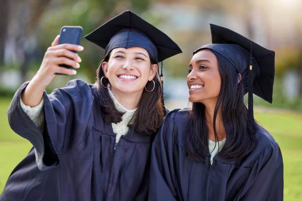 istock Cropped shot of two attractive young female students taking selfies while celebrating on graduation day 1359164200