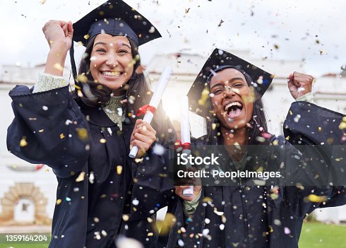 istock Cropped portrait of two attractive young female students celebrating on graduation day 1359164204