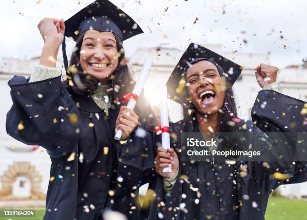 Cropped Portrait Of Two Attractive Young Female Students Celebrating On Graduation Day Stock Photo - Download Image Now