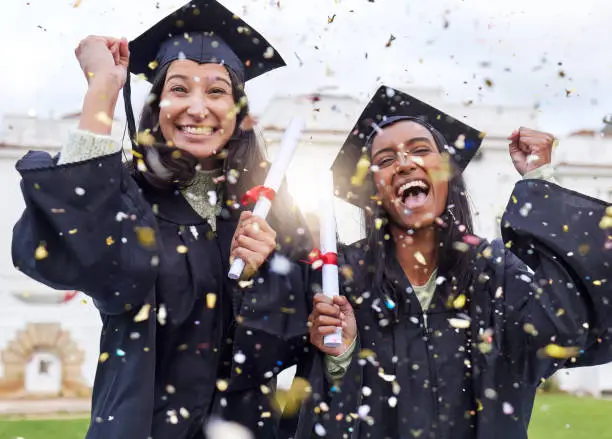 Photo of Cropped portrait of two attractive young female students celebrating on graduation day