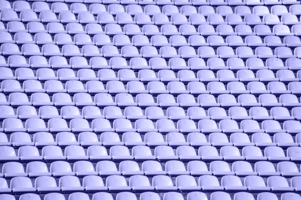 lots of rows with yellow seats for people on the football field in the summer lots of rows with yellow seats for people on the football field in the summer. baseball stadium chairs stock pictures, royalty-free photos & images