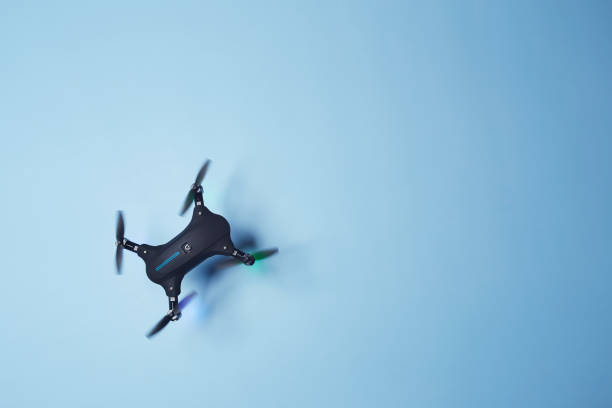 istock Drone flying above the bright solid blue fond background 1359165858