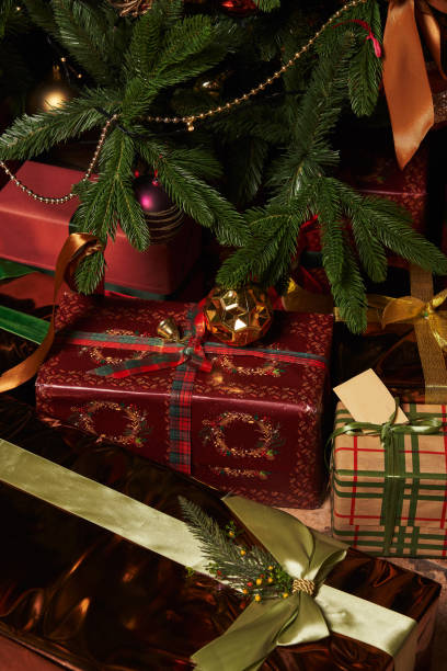 istock boxes with a gift in different beautiful packaging with a beautiful ribbon under a beautiful decorated Christmas tree 1359167145